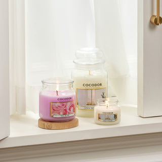 a group of candles on a window sill