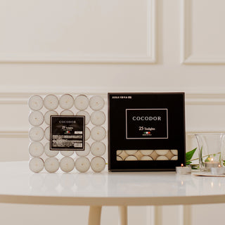 a white box with black label next to a black box with white candles