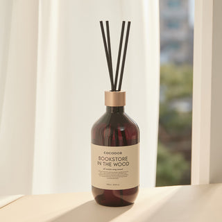 a bottle of reed diffuser with sticks