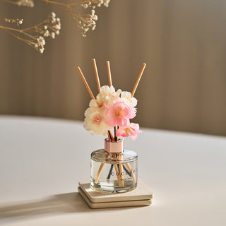 a small glass bottle with flowers in it