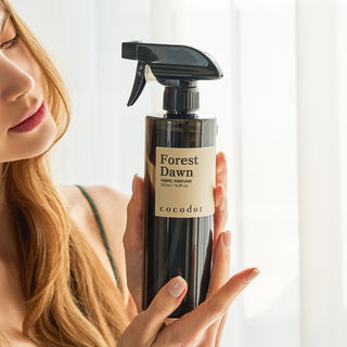 a woman holding a spray bottle