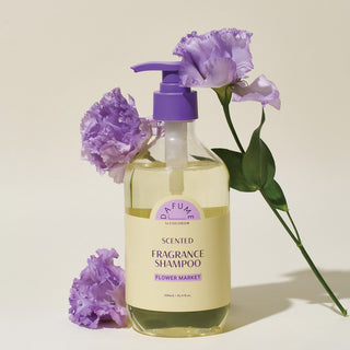 a bottle of perfume with purple flowers