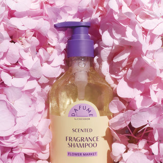 a bottle of fragrance shampoo on pink flowers