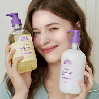 a woman holding two bottles of shampoo