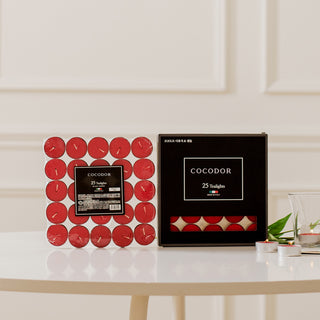 a box of candles and a candle holder on a table