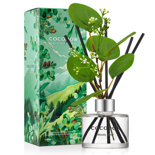 a bottle of reed diffuser with flowers and leaves