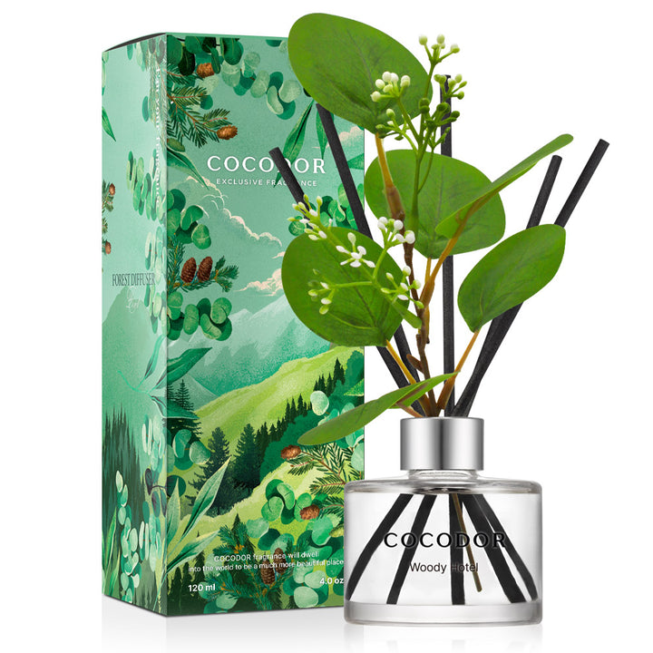 a bottle of reed diffuser with flowers and leaves