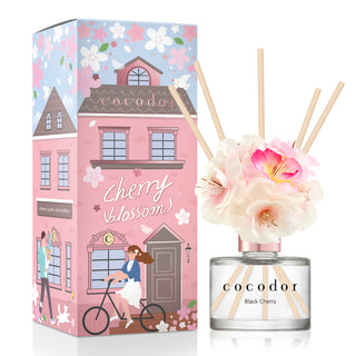a bottle of fragrance with flowers in it