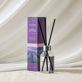 a bottle of reed diffuser with black sticks