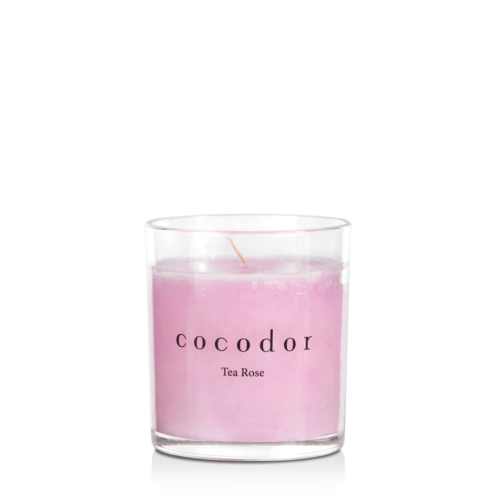 a pink candle in a glass
