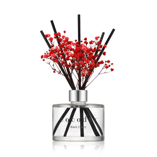 a glass bottle with red flowers in it