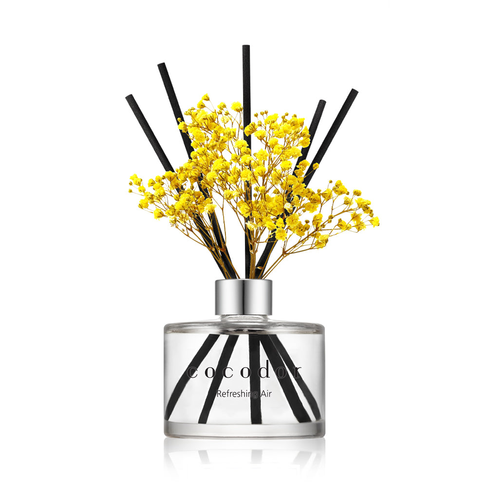 a glass bottle with yellow flowers in it