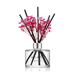 a glass bottle with pink flowers in it