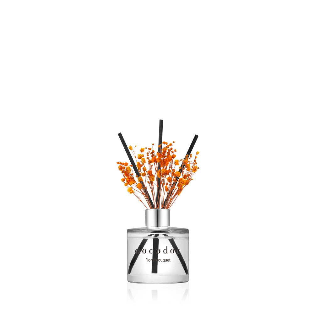a glass bottle with orange flowers