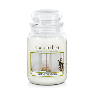 a white candle in a glass jar