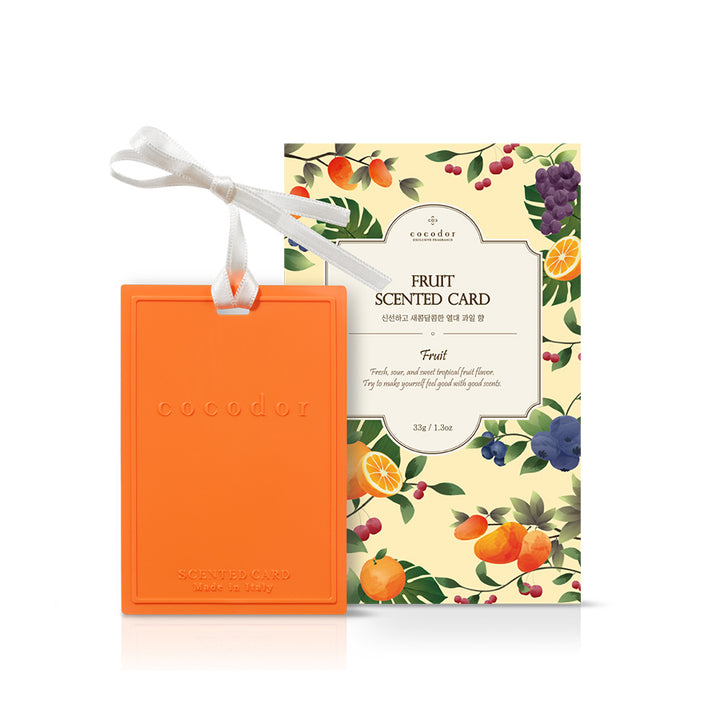 an orange scented card with a white ribbon
