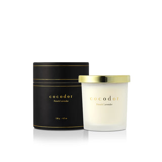 a white candle in a black container