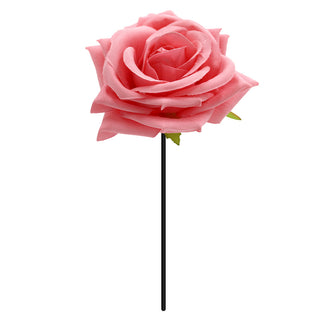 a pink rose on a stick